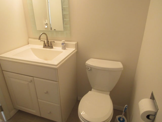 bathroom with vanity, tile patterned floors, and toilet