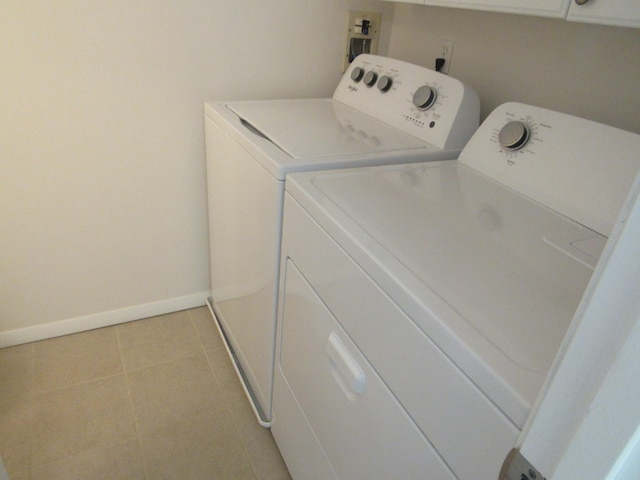 laundry room with light tile patterned flooring and washer and dryer