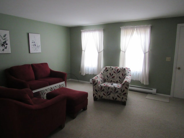 living room with baseboard heating and carpet