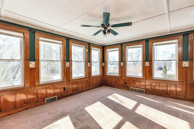 unfurnished sunroom with a wealth of natural light and ceiling fan