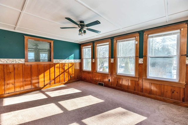 unfurnished sunroom with ceiling fan