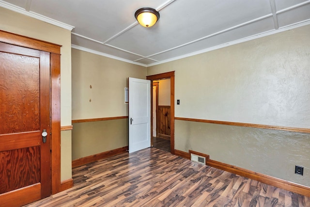 empty room featuring ornamental molding and dark hardwood / wood-style floors