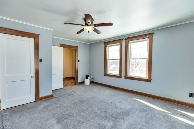 unfurnished bedroom with ornamental molding, light carpet, and ceiling fan