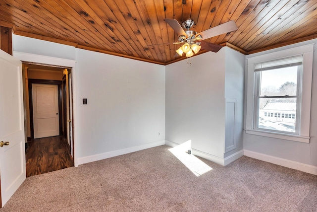 unfurnished room featuring ceiling fan, ornamental molding, wooden ceiling, and dark colored carpet