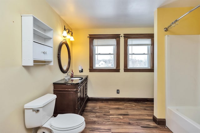 full bathroom with vanity, hardwood / wood-style flooring, bathtub / shower combination, and toilet