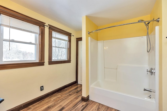 bathroom with shower / tub combination and hardwood / wood-style floors