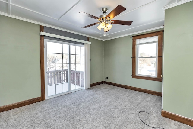 carpeted empty room featuring ornamental molding and ceiling fan