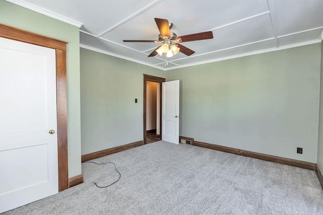 unfurnished bedroom with ceiling fan, ornamental molding, and carpet