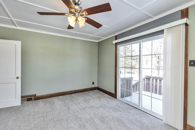 carpeted empty room featuring ornamental molding and ceiling fan