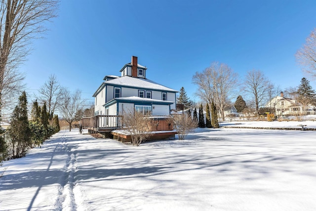 snow covered house with a deck