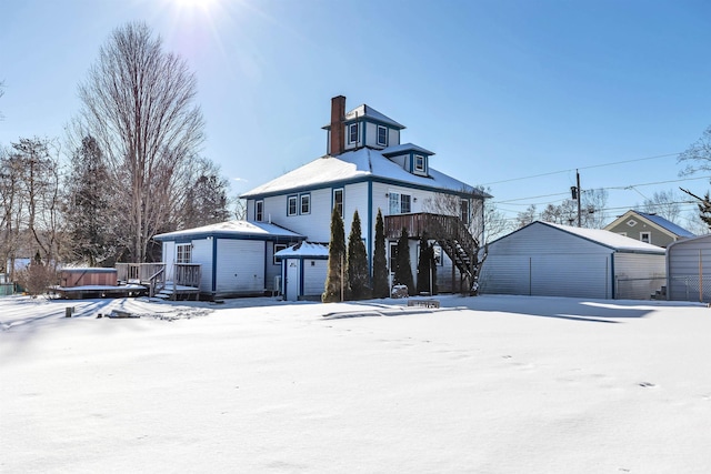 view of front of house with a garage and an outdoor structure