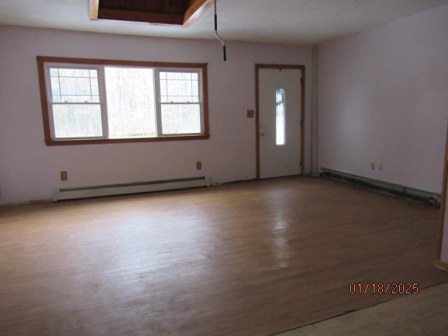 entryway with light hardwood / wood-style flooring and a baseboard heating unit