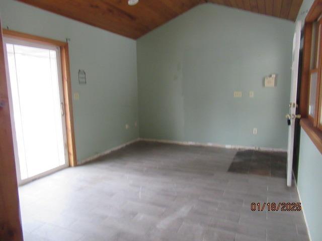 unfurnished room featuring vaulted ceiling and wood ceiling