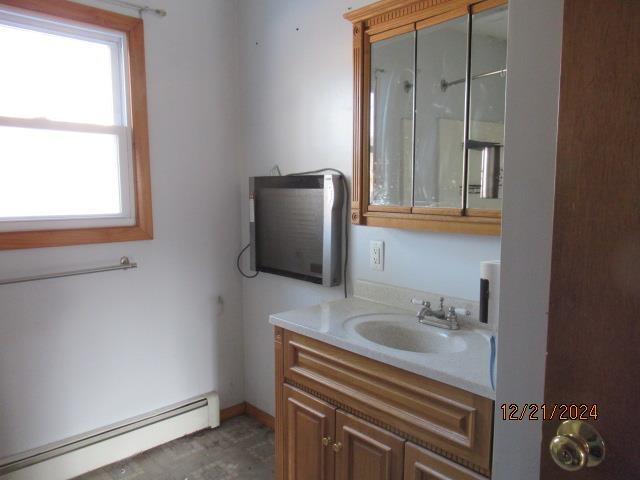 bathroom featuring a baseboard radiator and vanity