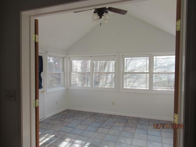 spare room with ceiling fan and vaulted ceiling