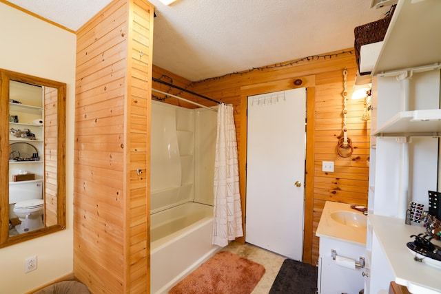 full bathroom featuring vanity, shower / bath combo, a textured ceiling, and wood walls