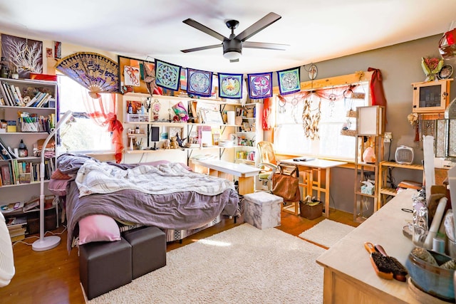 bedroom with ceiling fan and hardwood / wood-style floors