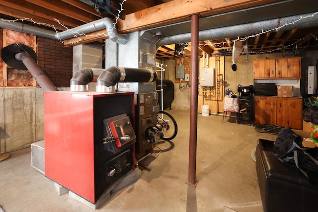 basement with electric panel and water heater