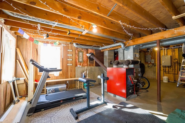 workout room featuring water heater and electric panel