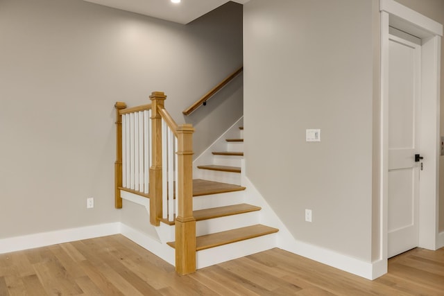 staircase featuring hardwood / wood-style floors