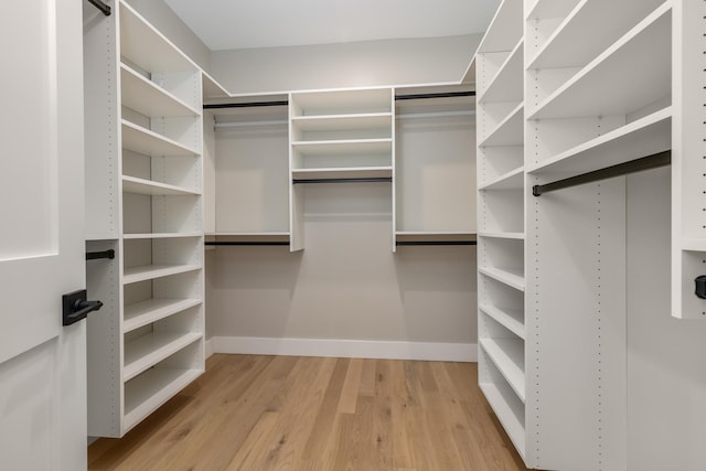 spacious closet with light hardwood / wood-style floors