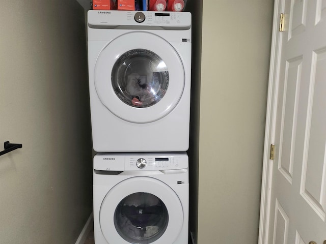 washroom featuring stacked washer / drying machine