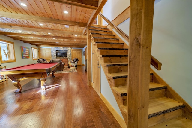 game room featuring wood ceiling, hardwood / wood-style flooring, billiards, a fireplace, and beamed ceiling