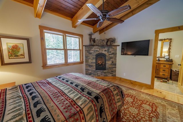 bedroom with wood ceiling, a fireplace, hardwood / wood-style floors, and vaulted ceiling with beams