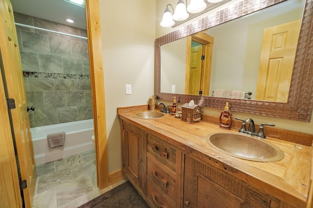 bathroom with tiled shower / bath and vanity