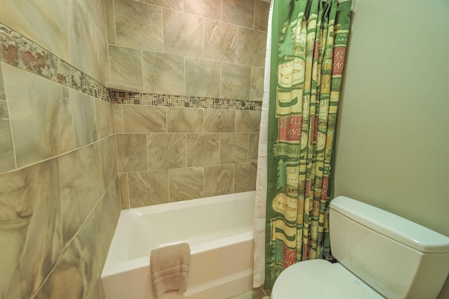 bathroom featuring shower / tub combo with curtain and toilet