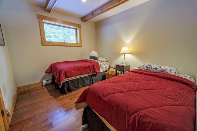 bedroom with baseboard heating, wood-type flooring, and beam ceiling