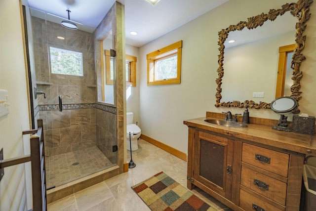 bathroom featuring vanity, toilet, and a shower with door