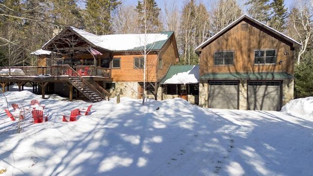 view of front of property with a garage and a wooden deck