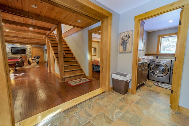 interior space featuring beam ceiling, wood ceiling, light hardwood / wood-style floors, and independent washer and dryer