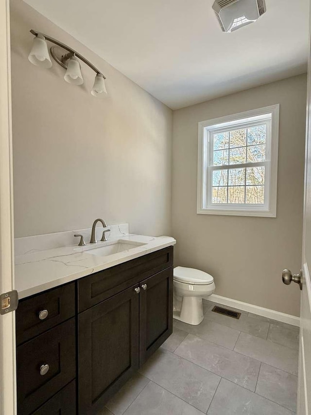 bathroom with vanity, toilet, and tile patterned flooring