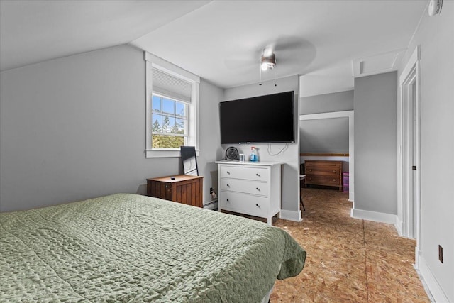 bedroom with vaulted ceiling, ceiling fan, and baseboard heating