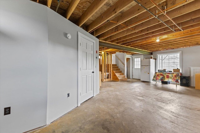 basement with white refrigerator