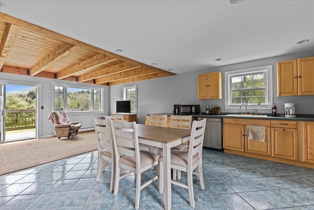 kitchen with sink, wood ceiling, stainless steel dishwasher, dark tile patterned floors, and beam ceiling