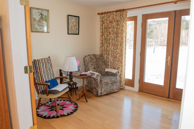 living area with plenty of natural light and light wood-type flooring