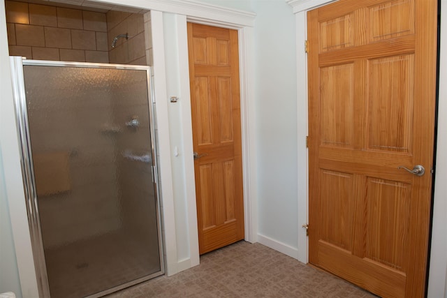 bathroom with a shower with door