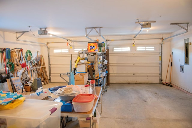 garage with a garage door opener and electric panel