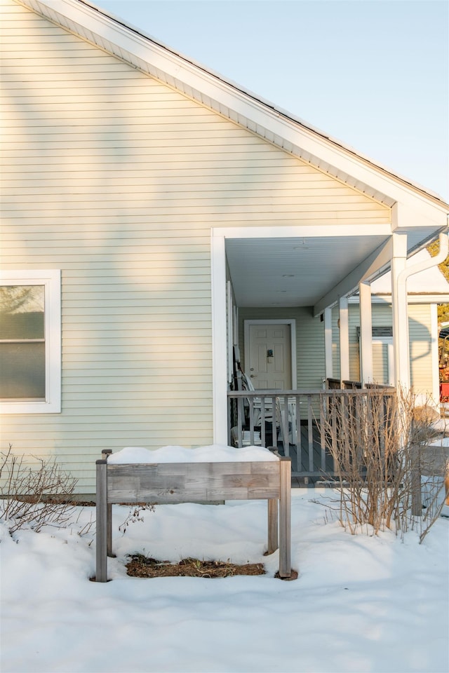 view of snow covered property entrance