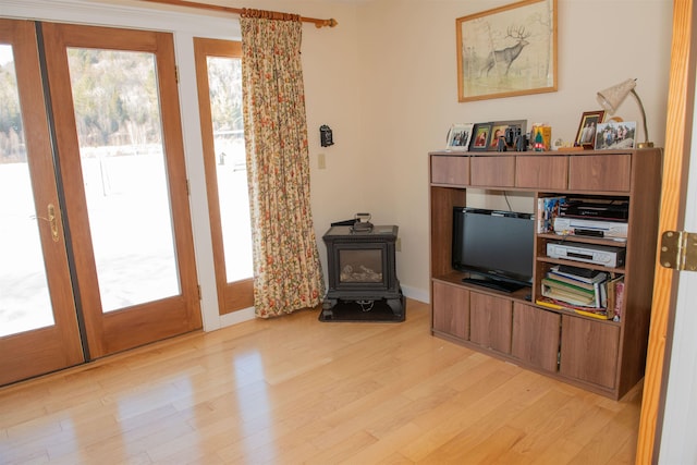 living room featuring a wood stove and light hardwood / wood-style floors