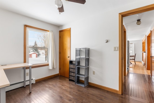 home office featuring a baseboard radiator, dark hardwood / wood-style floors, and ceiling fan