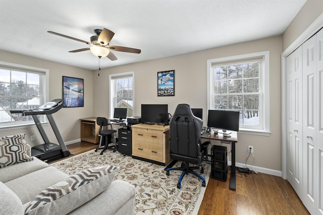 home office featuring wood-type flooring, plenty of natural light, a textured ceiling, and ceiling fan