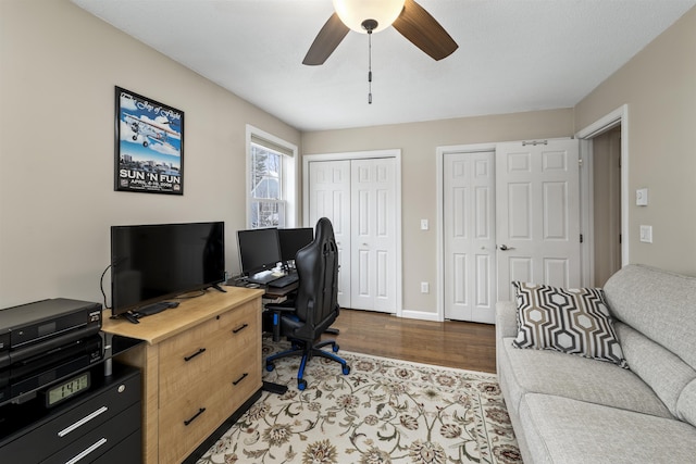 home office featuring hardwood / wood-style floors and ceiling fan