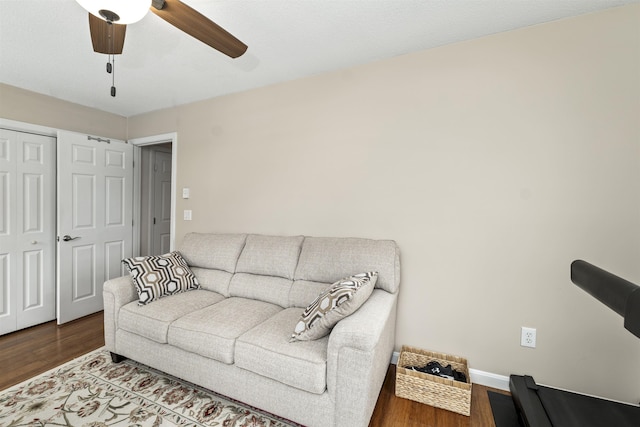 living room with wood-type flooring and ceiling fan