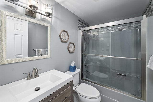 full bathroom with vanity, enclosed tub / shower combo, and toilet