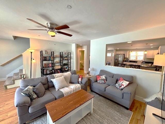 living room with ceiling fan and light wood-type flooring