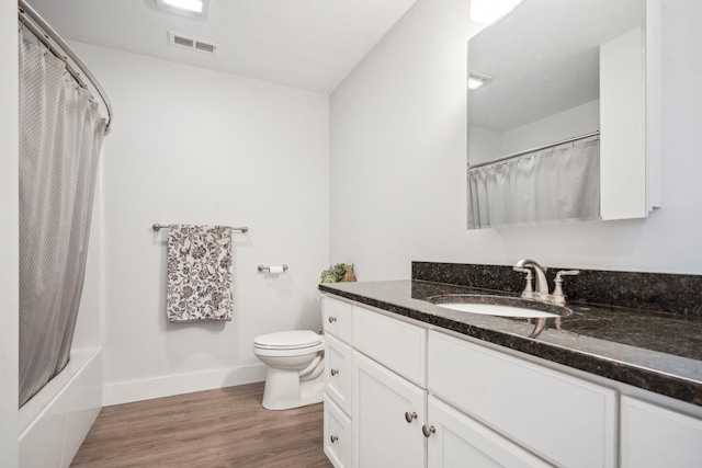 full bathroom featuring vanity, toilet, hardwood / wood-style floors, and shower / bath combo